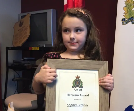 A girl is given Heroism Award