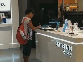 A Boy with No Computer Uses Tablet at Store to do Homework